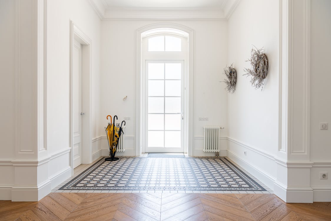 entryway renovation ideas with bright modern entry hall, durable tile flooring and natural light